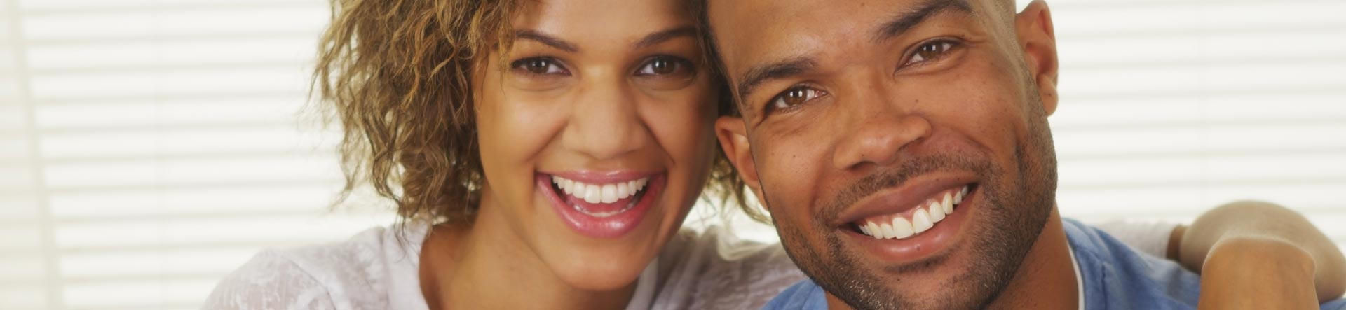 Happy african american couple after having dental crown treatment